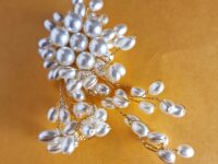 multi pearl style brooch with twist gold plated wire.