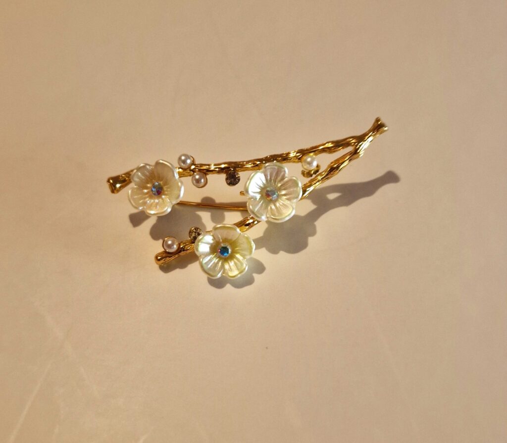 flower twig brooch on cream background