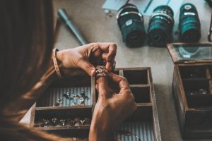 jeweller at the bench working on a ring