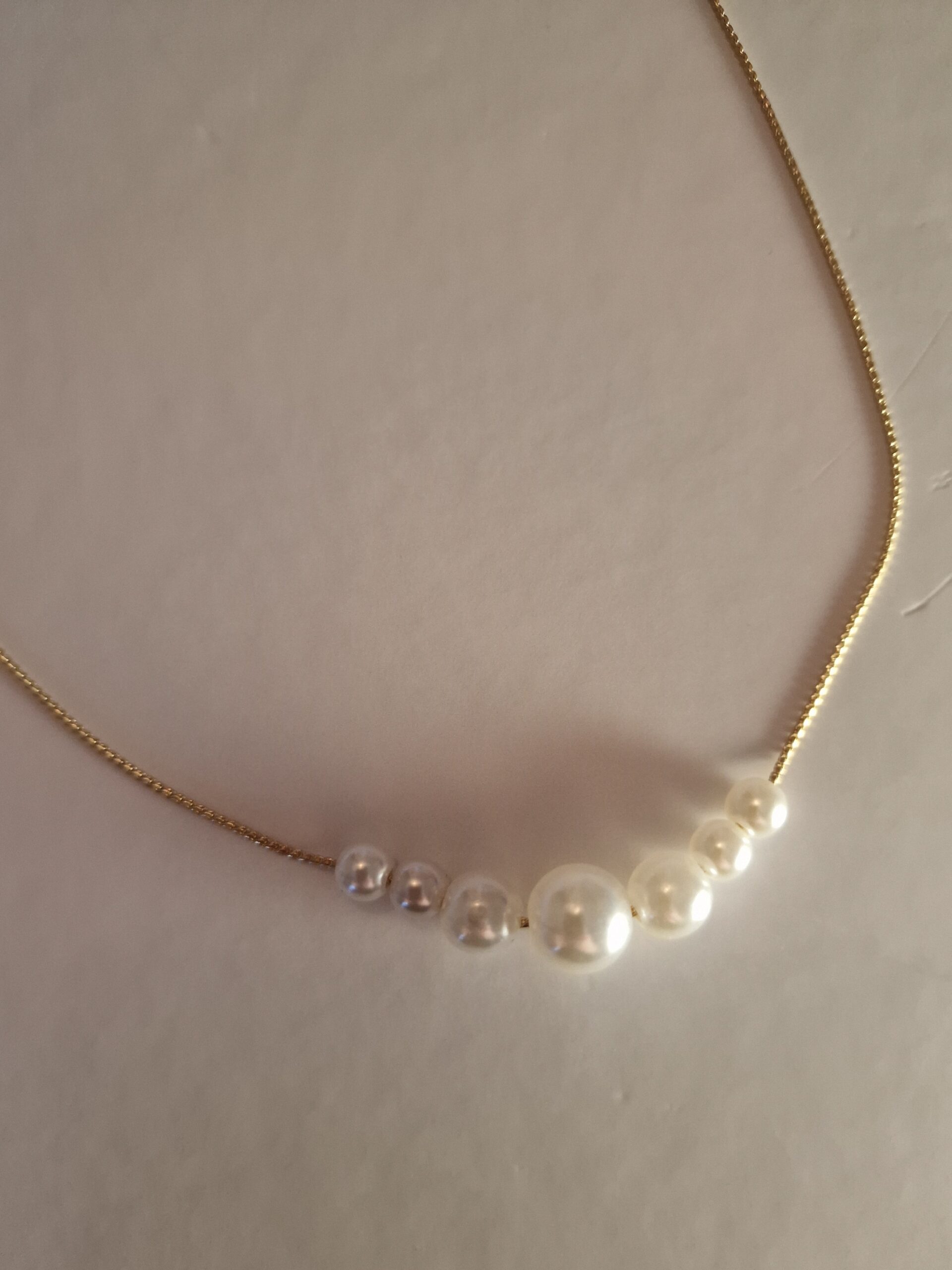 multi pearl necklace on gold plated chain.