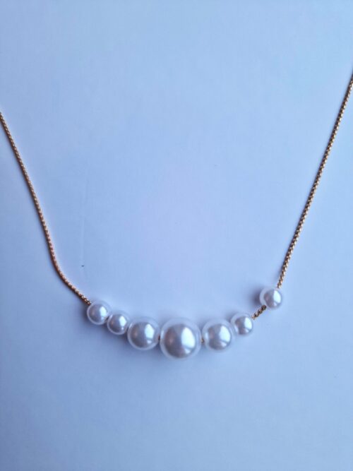 multi pearl necklace on gold plated chain.