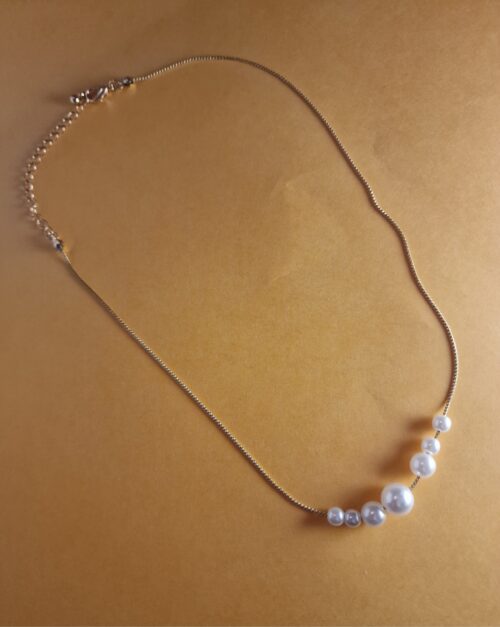 multi pearl necklace on gold plated chain.
