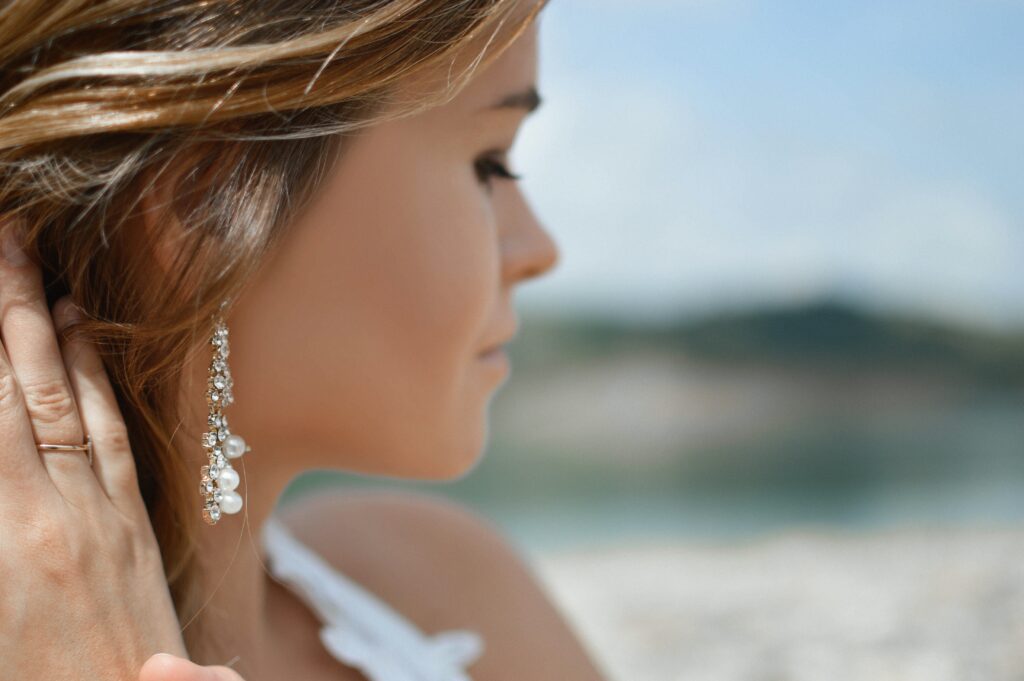 woman on beach wearing an earring