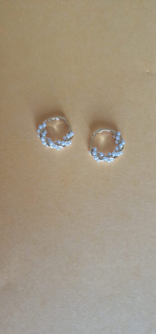 twisted gold plated pearl hoop earrings on white background