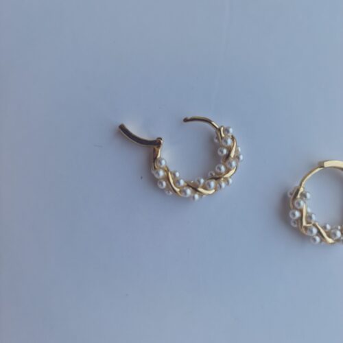 twisted gold plated pearl hoop earrings on white background