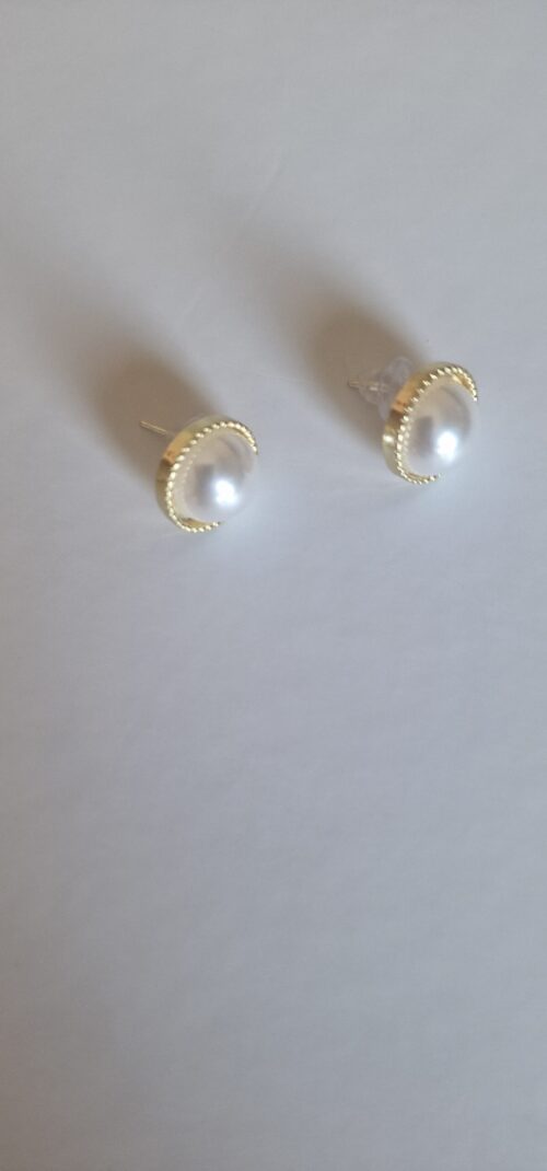 gold plated earrings with pearl on a white background