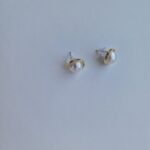 gold plated earrings with pearl on a white background