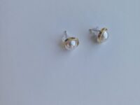gold plated earrings with pearl on a white background