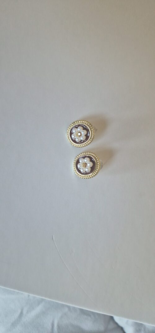 Two flower pearl gold plated earrings with pearl detail on a white background