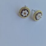 Two flower pearl gold plated earrings with pearl detail on a white background