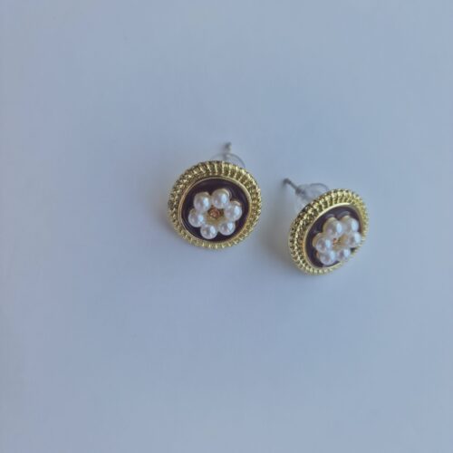 Two flower pearl gold plated earrings with pearl detail on a white background