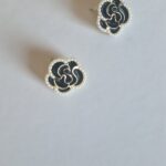 Black burgundy gold rose earrings with pearl detail on a white background.