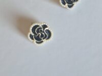 Black burgundy gold rose earrings with pearl detail on a white background.