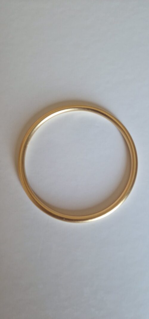Bold gold bracelet on a white background.