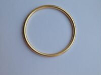 Bold gold bracelet on a white background.