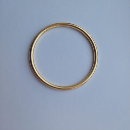 Bold gold bracelet on a white background.